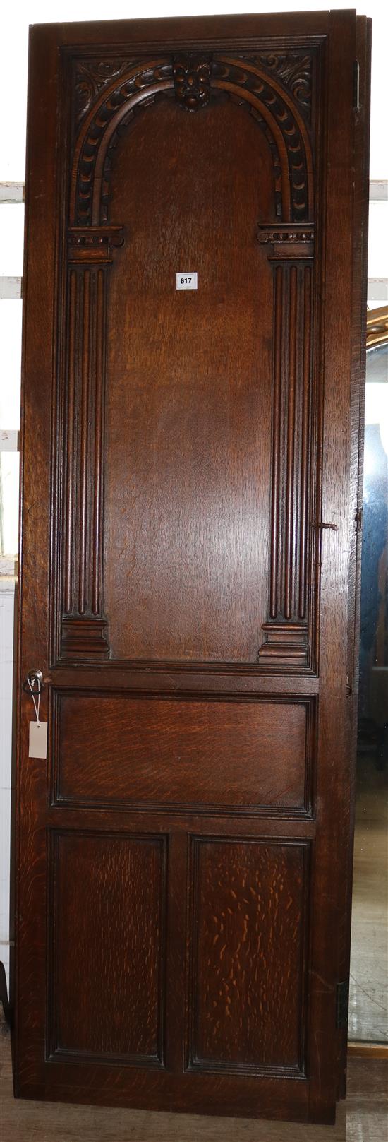A pair of 18th century style arcaded and panelled oak doors H. 7ft. W.2ft 1in.